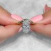3 carat Oval Diamond Compass Prong Solitaire Ring held by hand