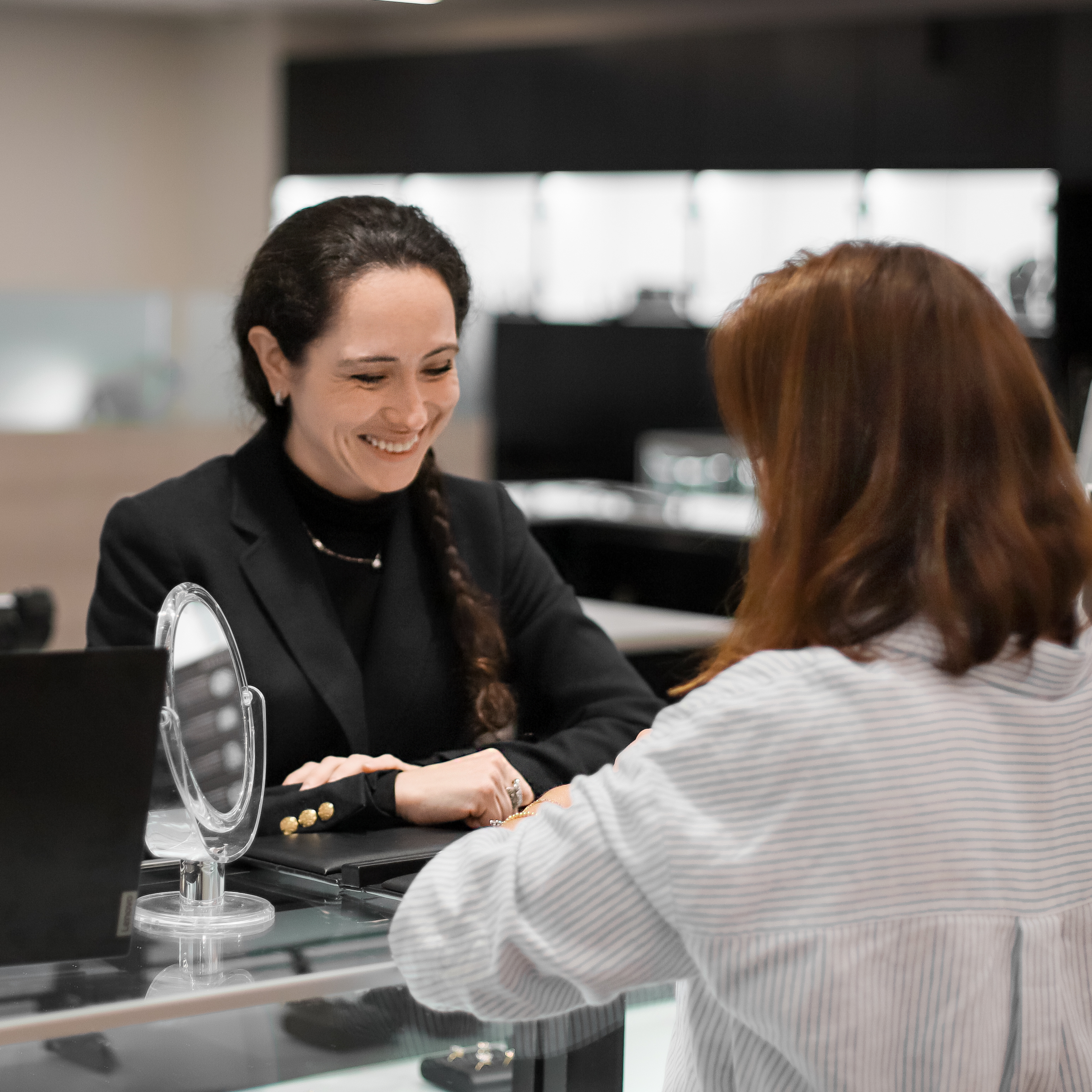 diamond design consultant assisting client jewelry showcase