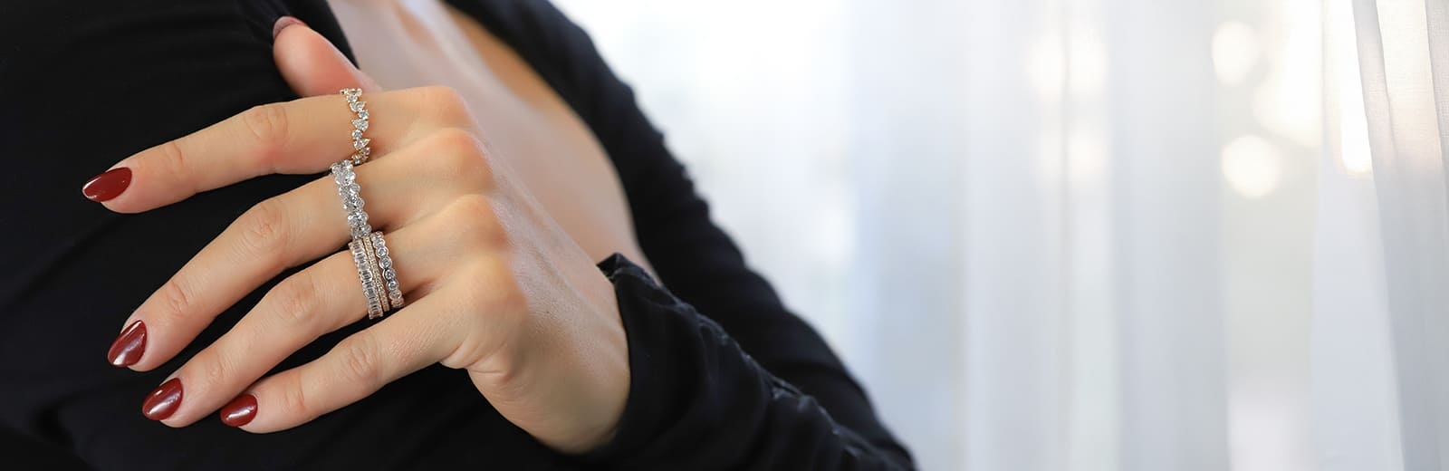Woman's Hand With Diamond Wedding Bands.