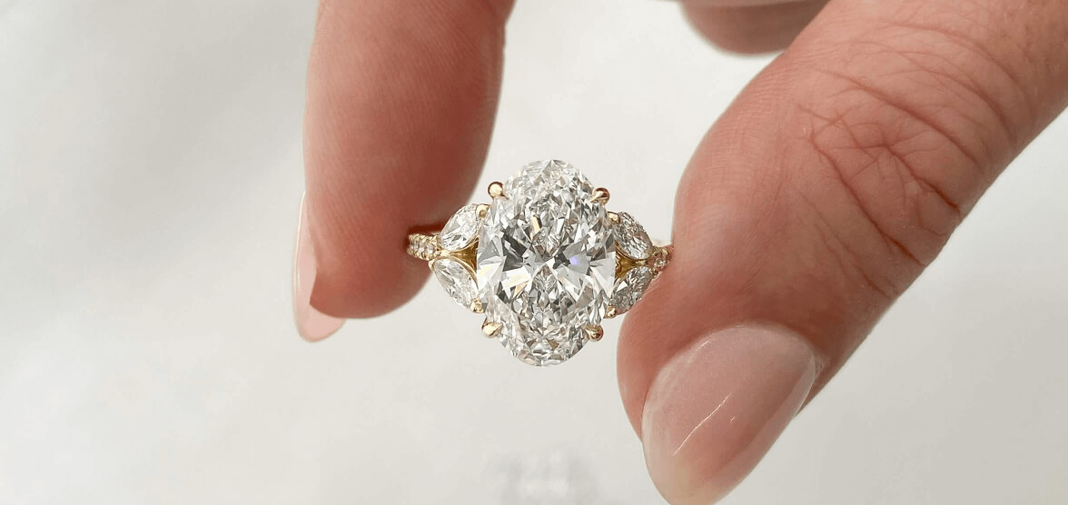 Fingers Holding Diamond Engagement Ring